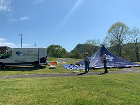 Southwest Virginia Community Health Systems staff setting up tent for COVID-19 drive thru testing event