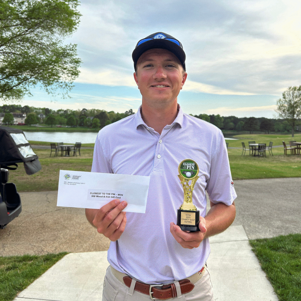 Young man smiling holding a trophy and an envelope