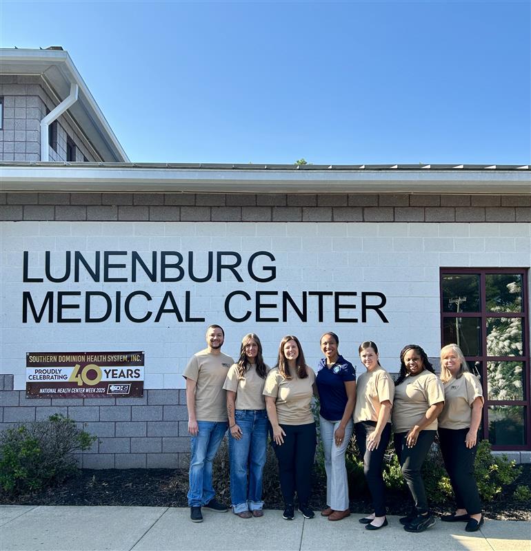 Adrienne stands outside the Lunenburg Medical Center with six members of Southern Dominion's staff.