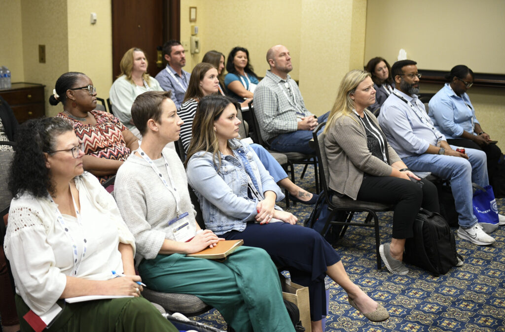 A group of people sit in a seminar