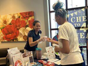 Adrienne tabling at a member health center.