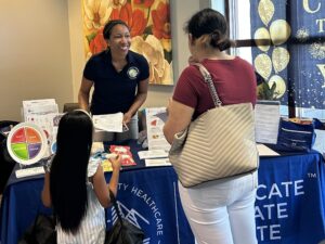 Adrienne tabling at a member health center.