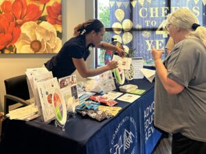 Adrienne tabling at a member health center.