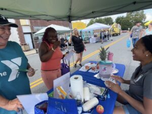 Adrienne tabling at a member health center block party.