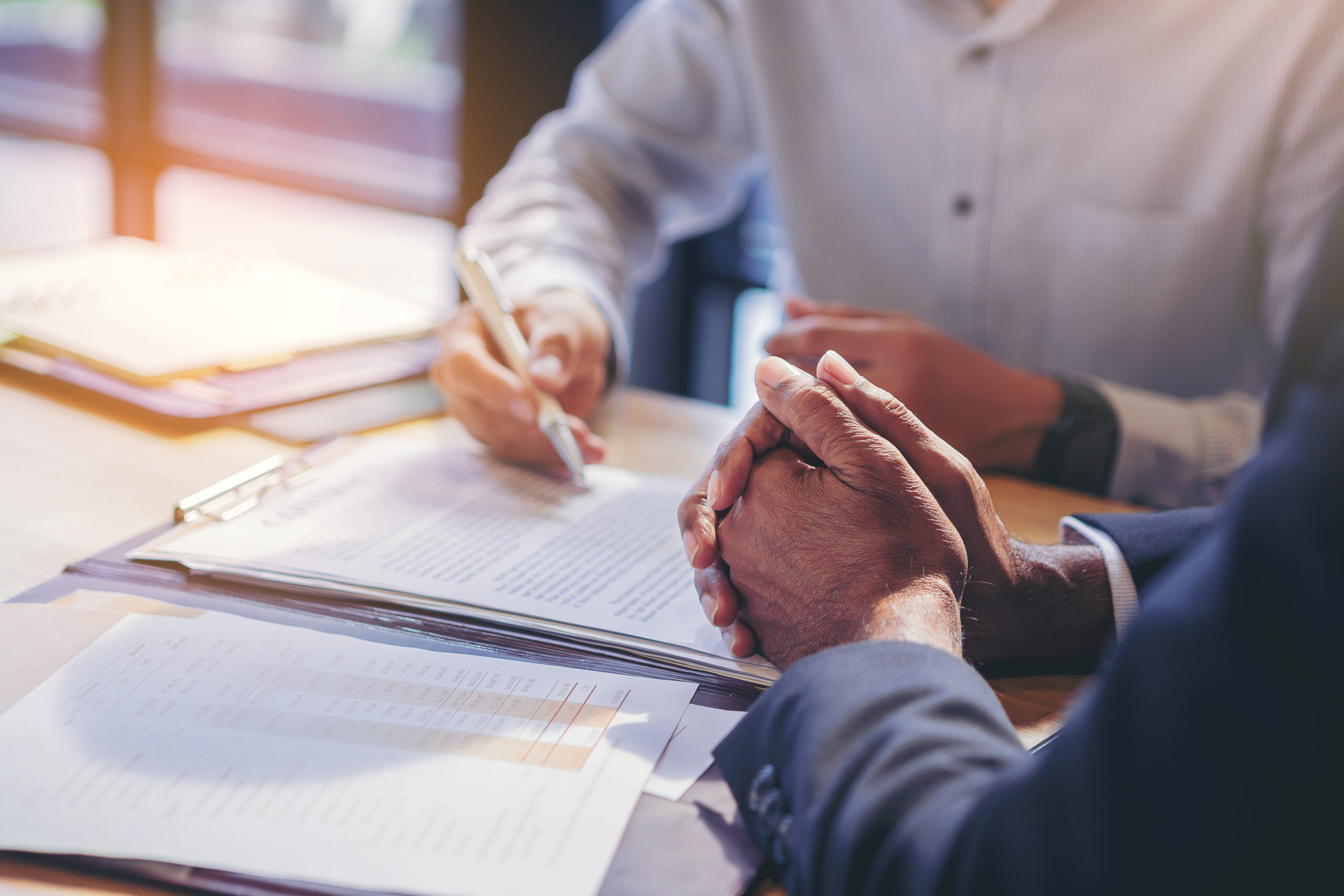 Stock photo of two businesspeople signing documents