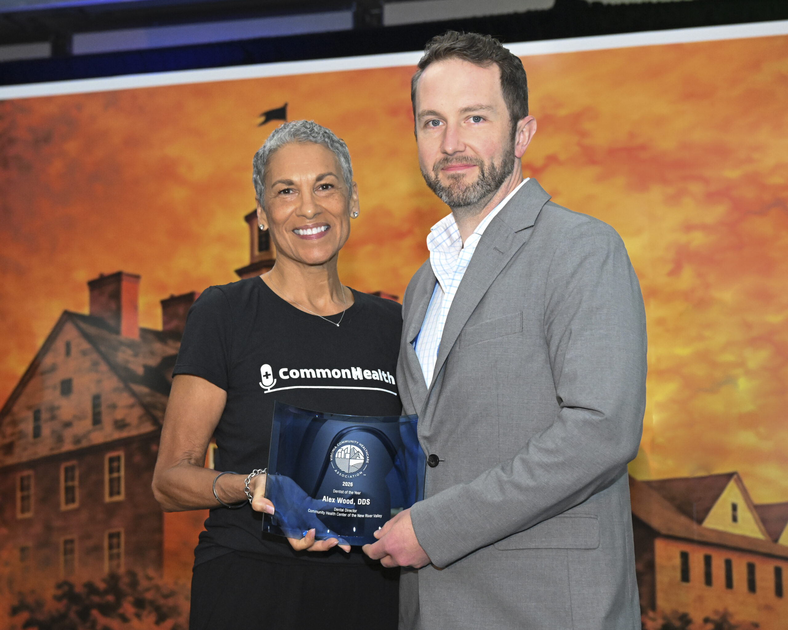 VCHA CEO Tracy Douglas and Dr. Alex Wood, Dental Director at the Community Health Center of the New River Valley, smile while holding the Dentist of the Year award