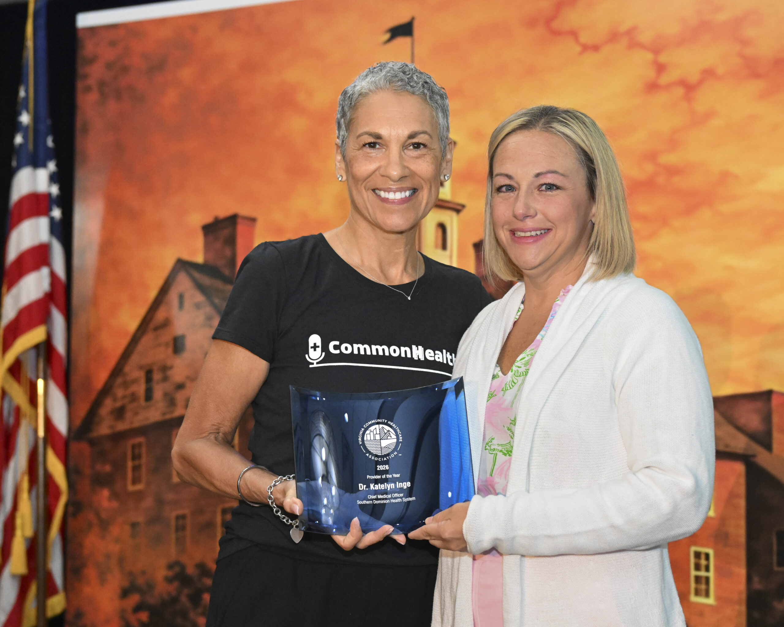 VCHA CEO Tracy Douglas and Dr. Katelyn Inge, Chief Medical Officer at Southern Dominion Health System, smile while holding an award