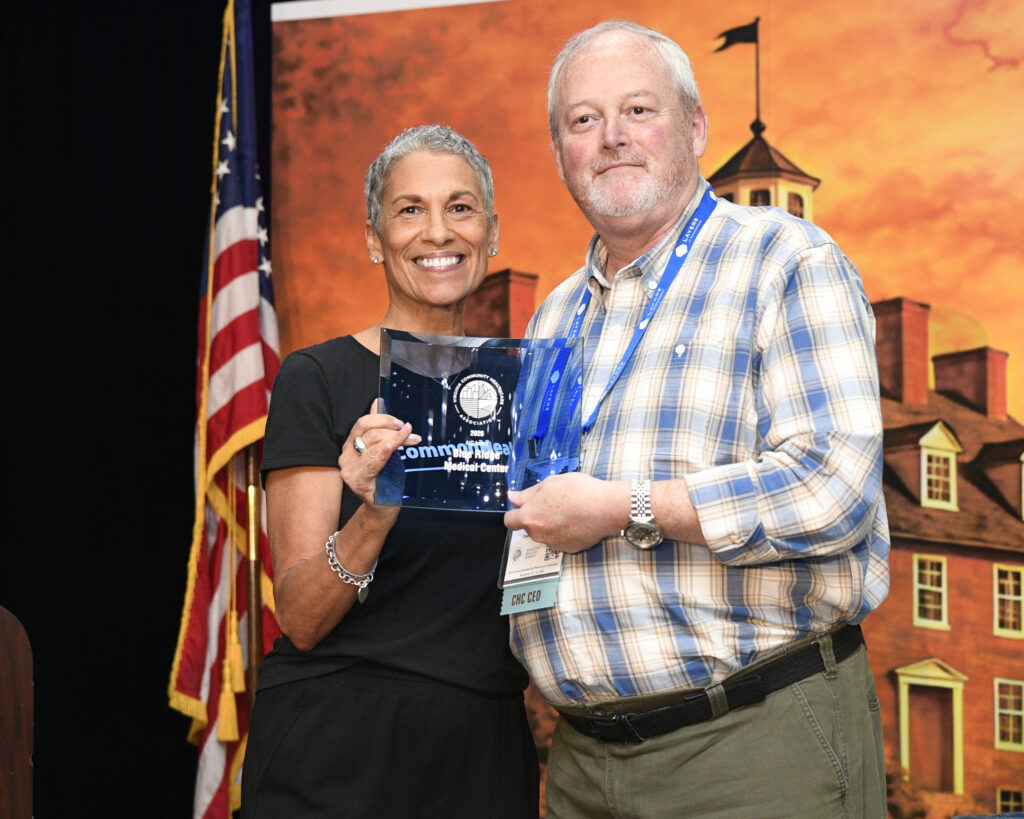 VCHA CEO Tracy Douglas and Blue Ridge Medical Center CEO Rodney Johnson smile while holding the 2026 A1c Award