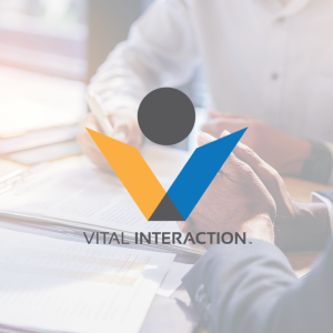Vital Interaction logo over a photo of someone signing a contract
