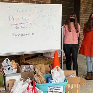 High Schoolers standing by their donations