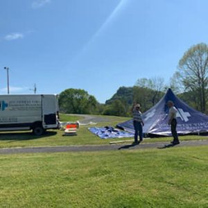 Southwest Virginia Community Health Systems staff setting up tent for COVID-19 drive thru testing event